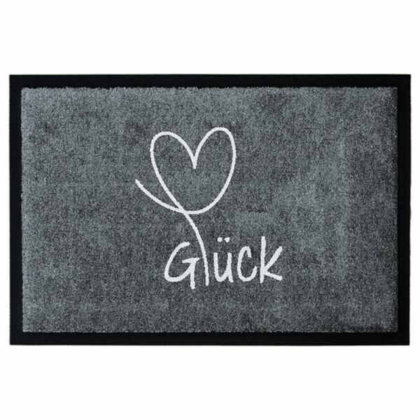 Waschbare Fußmatte von Glücksmatte.com mit einem Herz und der Aufschrift "Glück". Farbe Grau. Mit 2cm Gummirand. Umweltfreundlich in Deutschland hergestellt.