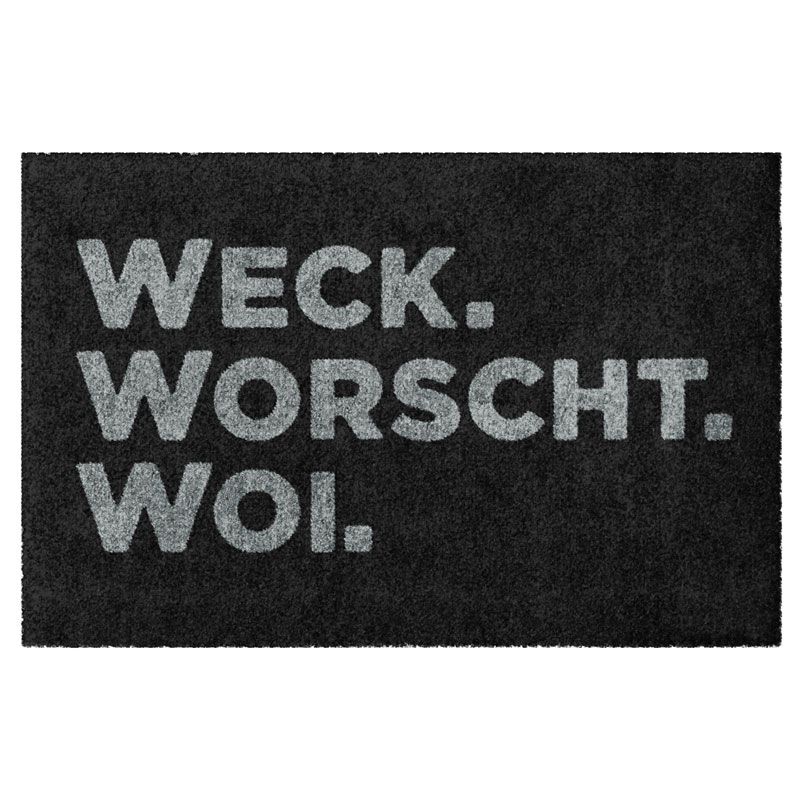 Waschbare Fußmatte von Glücksmatte.com mit der Aufschrift "Weck. Worscht. Woi.". Ohne Gummirand. Umweltfreundlich in Deutschland hergestellt.