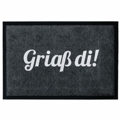 Waschbare Fußmatte mit dem Text Griaß di! in weiß auf schwarz. Mit Gummirand.