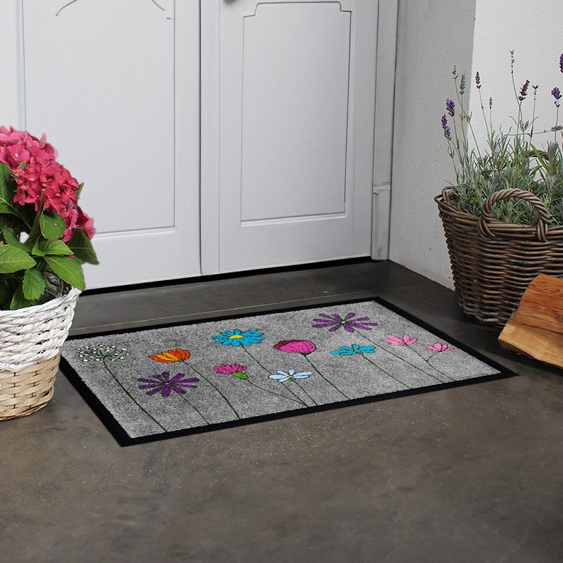 Produktbild einer waschbaren Fußmatte Powerflower in Grau mit buntem Blumenmotiv. Mit Rand.